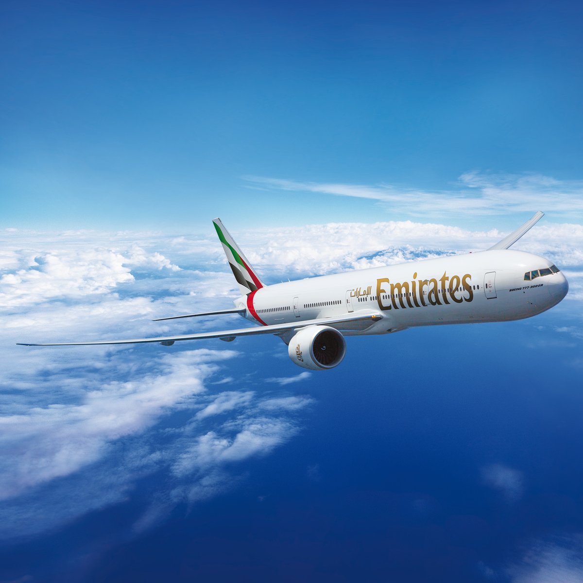 Emirates Boeing 777 in flight above the clouds