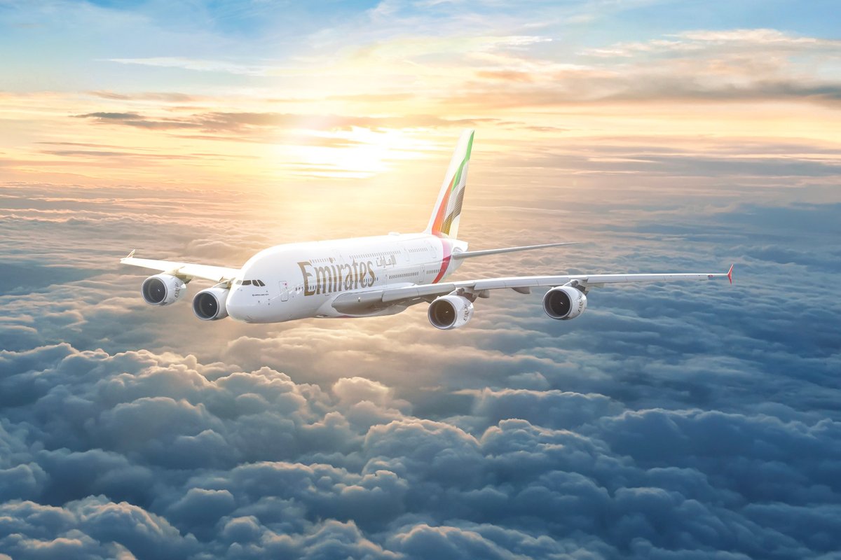 Emirates Airbus A380 flying above the clouds at sunset